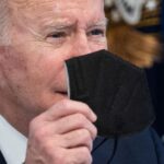 US President Joe Biden holds up a KN95 mask as he delivers an update on his Administrations whole-of-government COVID-19 surge response at the White House in Washington, DC, on January 13, 2022. Jim Watson | AFP | Getty Images